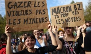Protesters hold placards during a demonstration by high school and university students supported by teachers, parents' associations, and education labour unions, in Paris as part of a nationwide day of demonstrations and blockades, voicing anger over overcrowded classrooms, teacher shortages and dilapidated school buildings, which students blame on years of underinvestment, France, October 6, 2026. The slogan reads
