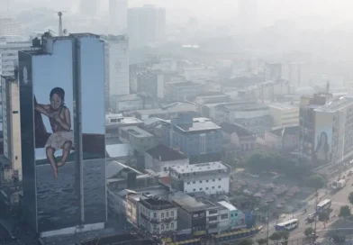 A drone view shows a mural on a building as smoke from Amazon wildfires and a burning landfill hangs over Manaus, Brazil, October 8, 2026. REUTERS/Bruno Kelly