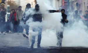 Demonstrators react amid tear gas, the day after a national day of demonstrations against the cost of living and rising fuel prices, in Paris, France, October 18, 2026. REUTERS/Abdul Saboor