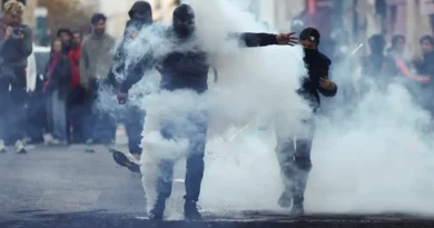 Demonstrators react amid tear gas, the day after a national day of demonstrations against the cost of living and rising fuel prices, in Paris, France, October 18, 2026. REUTERS/Abdul Saboor